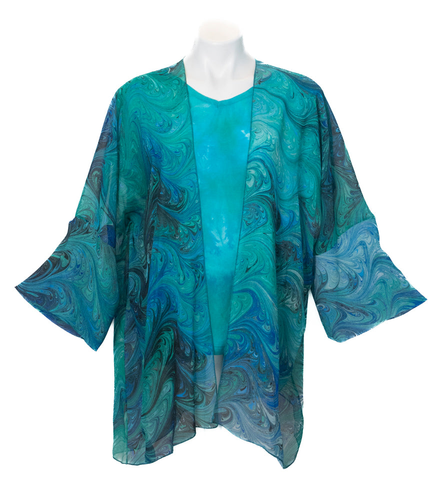 Marbled silk sheer wrap with cuffs against white background