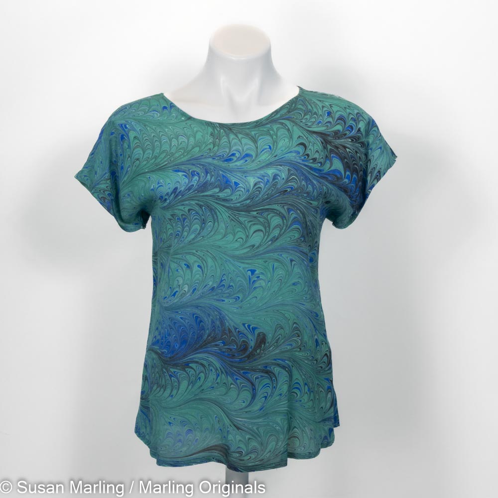 short sleeve round neck silk top in feathered pattern of emeralds, blue and black