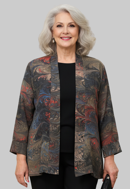 Woman wearing a marbled silk swing jacket over a black top and pants 