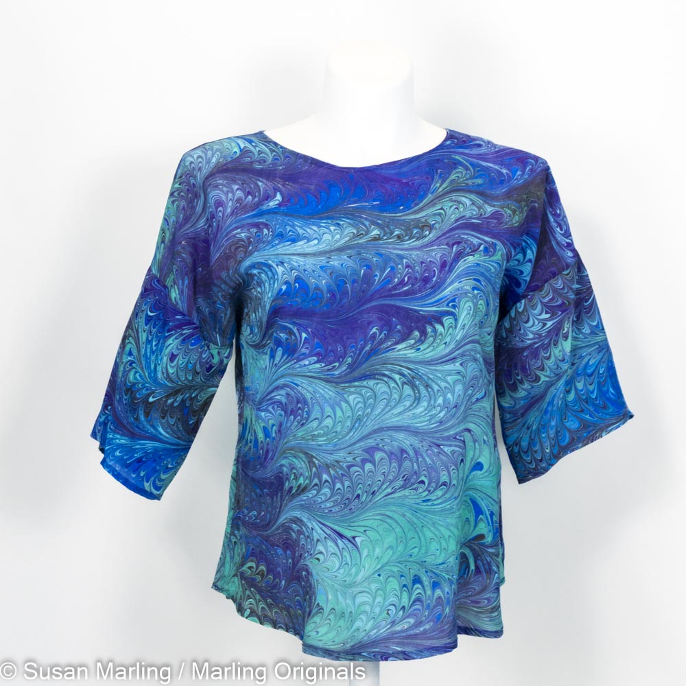 silk blouse with round neck, half sleeves.  Marbled pattern in blues, teal, aqua