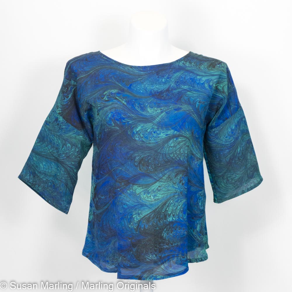 silk blouse with round neck and half sleeves.  Double marbled pattern in blues, greens and black