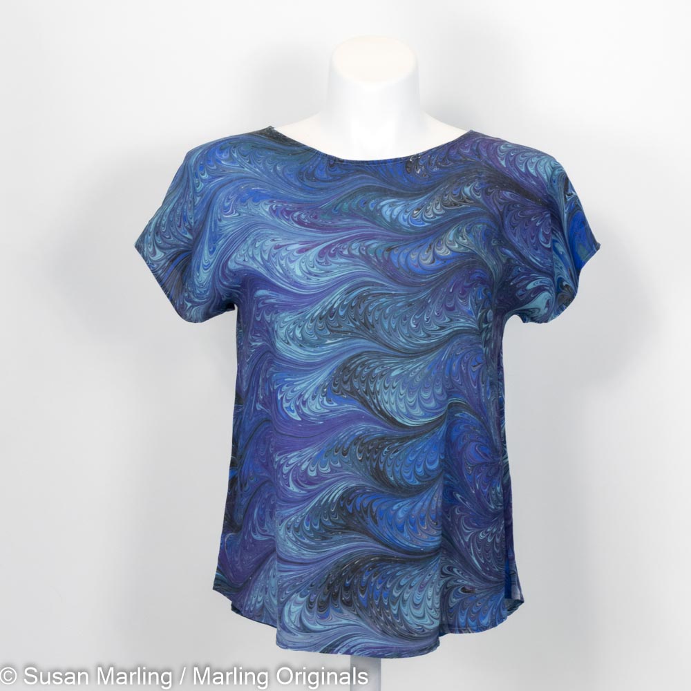 short sleeve silk blouse with round neck with a marbled pattern.  Teal, aqua, blue colors.