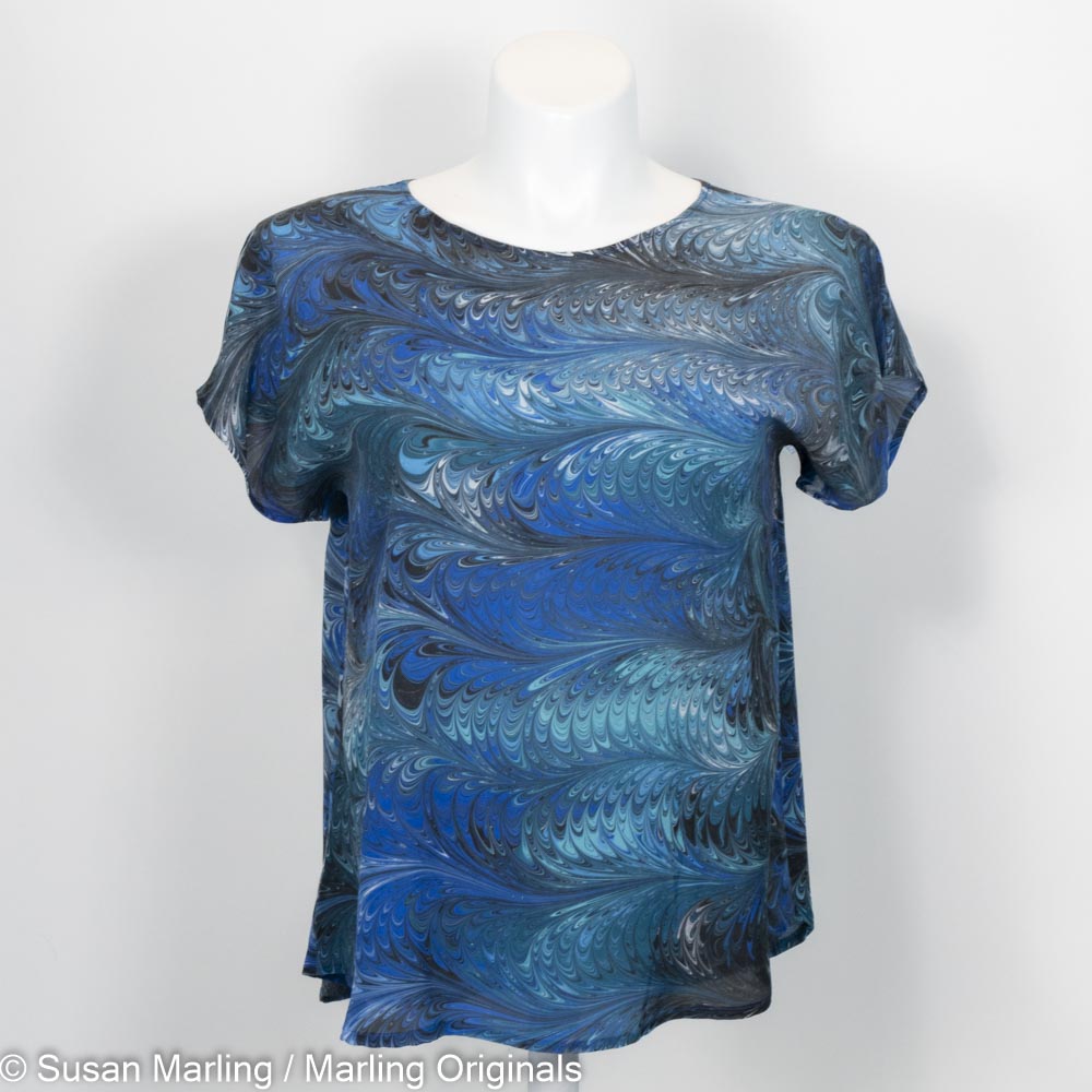 silk blouse with short sleeves marbled in a feathered pattern of blue, aqua, black and white