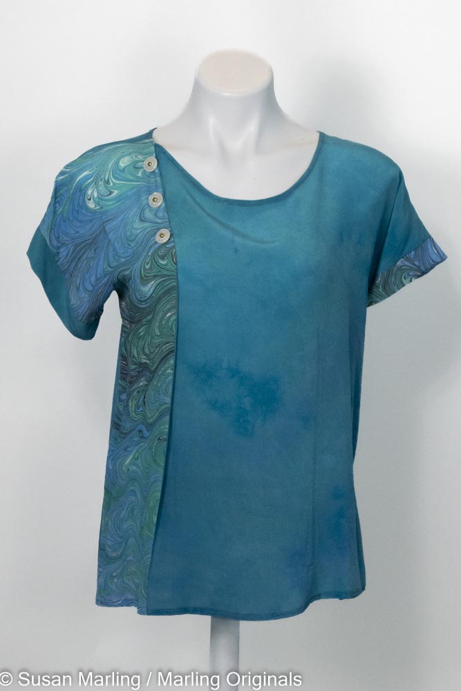 Hand dyed silk blouse in jade tone with a pleat created by marbled silk