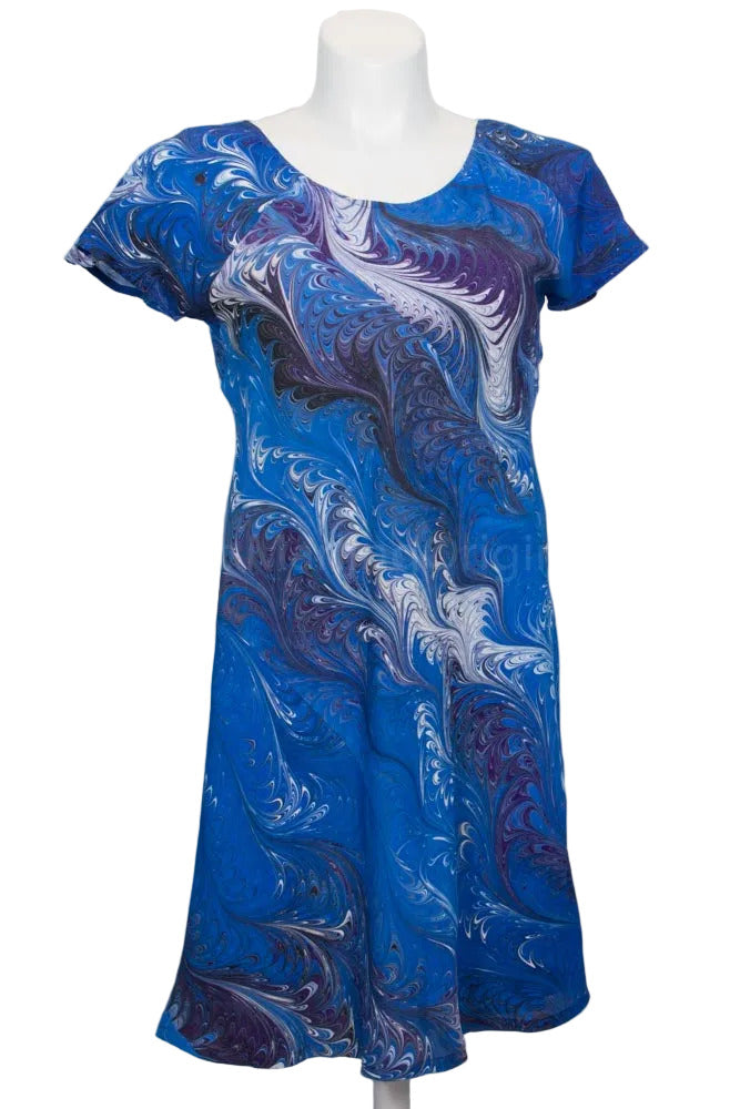 Blue and purple marbled silk dress on a mannequin against a white background