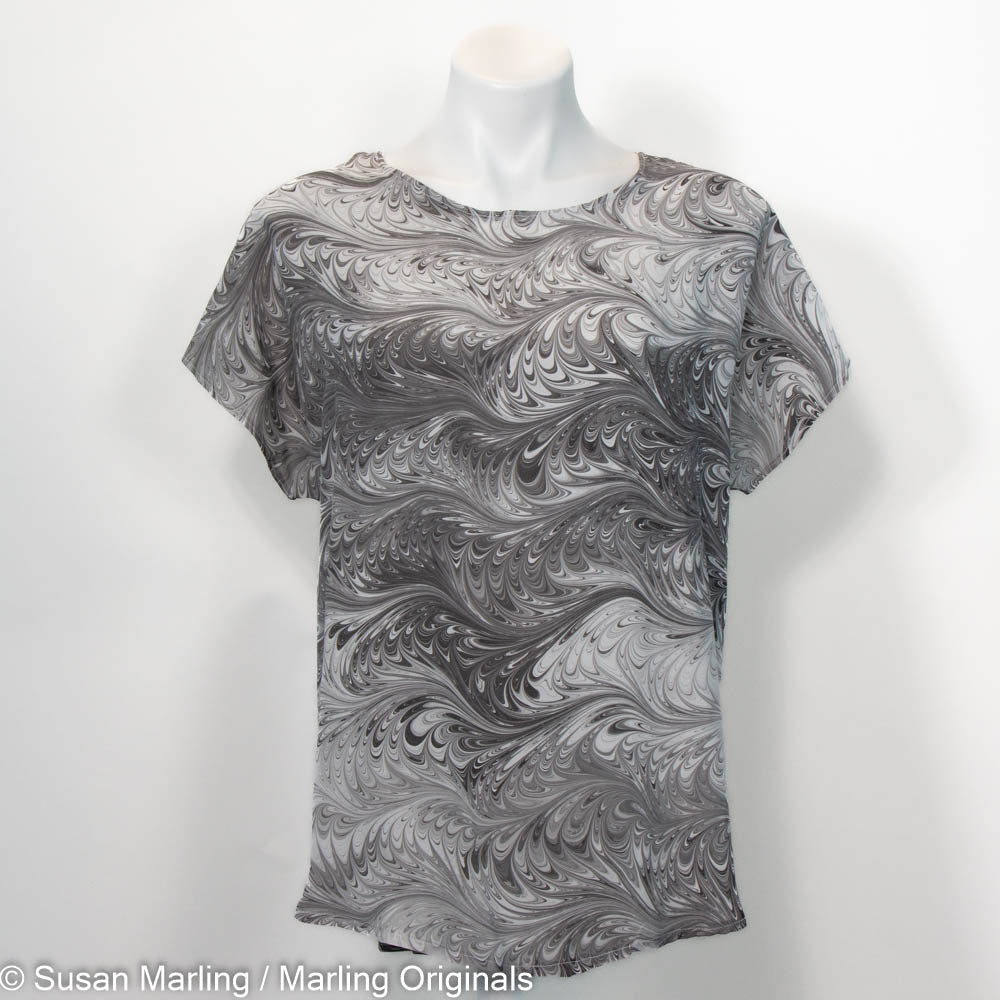 Short sleeve round neck top with grey, black and white marbled pattern.
