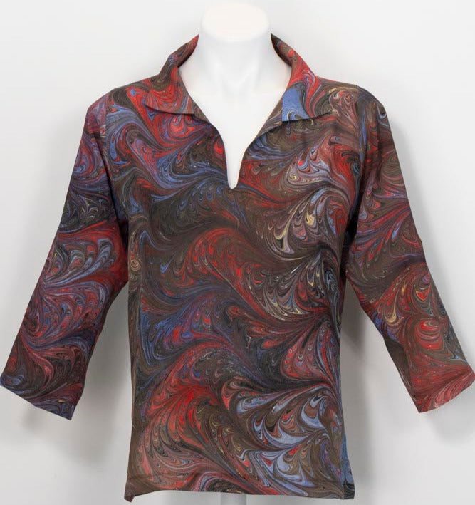 Patterned marbled silk shirt on a mannequin against a white background