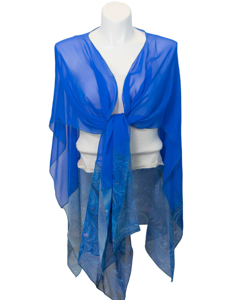 Blue sheer scarf draped over a white top on a mannequin against a white background