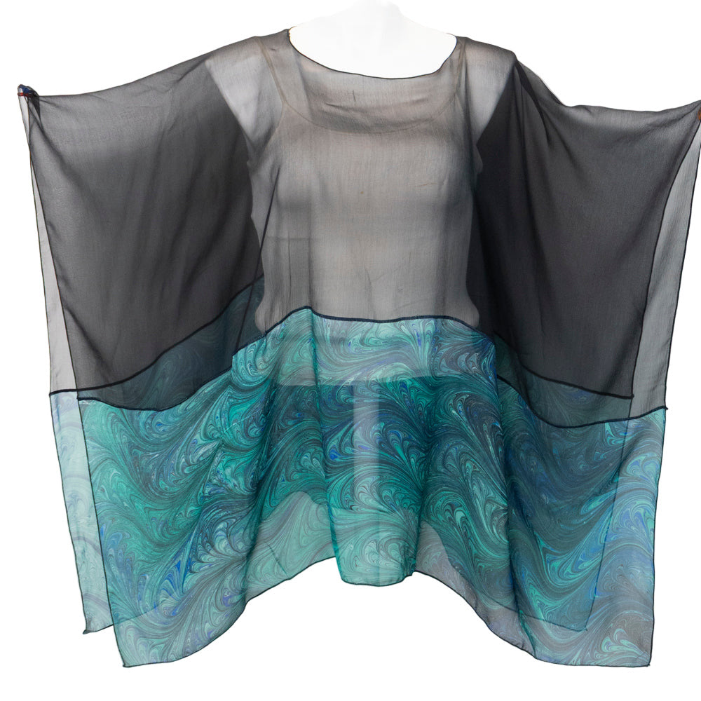 Sheer black and marbled emeralds poncho on a white background