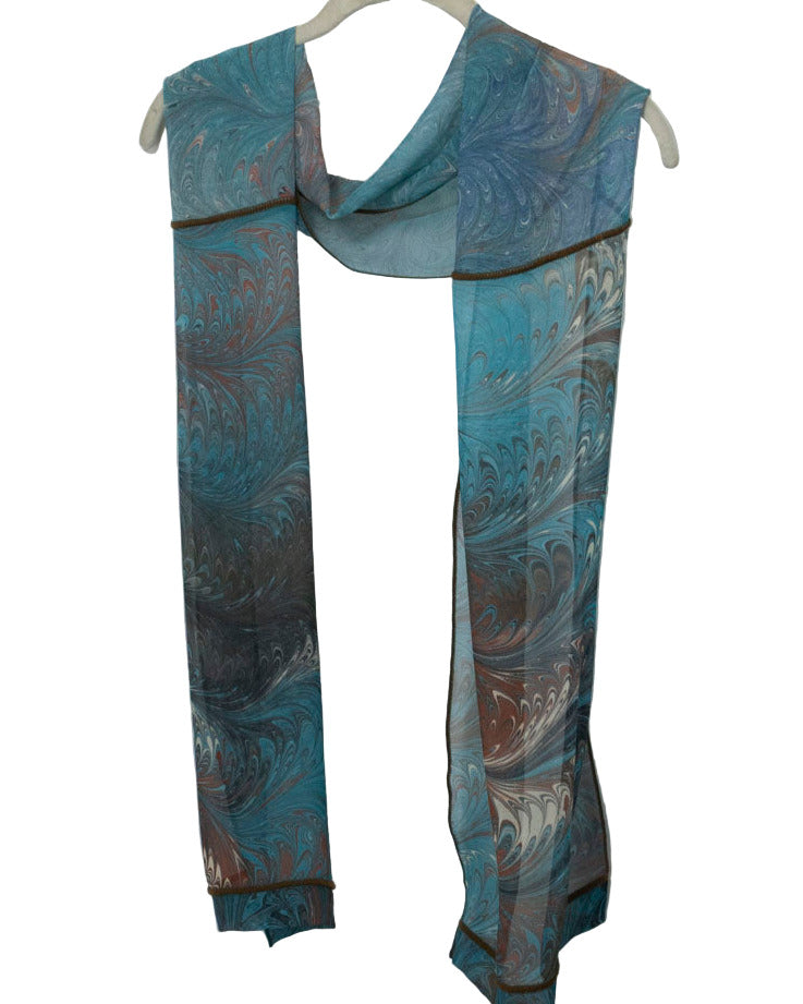 Teal and brown marbled scarf on a white hanger against a white background