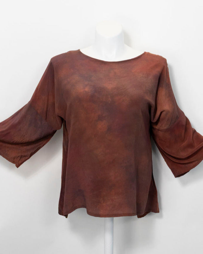 Brown hand dyed silk  shirt on a white mannequin against a white background