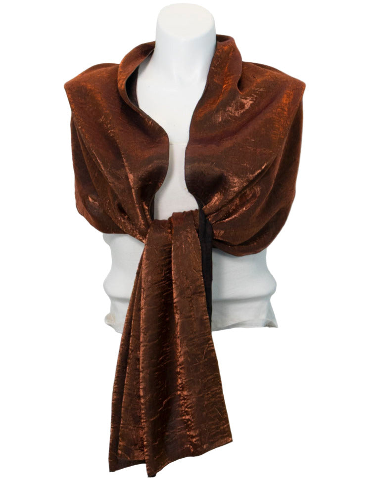 Brown scarf draped over a mannequin on a white background