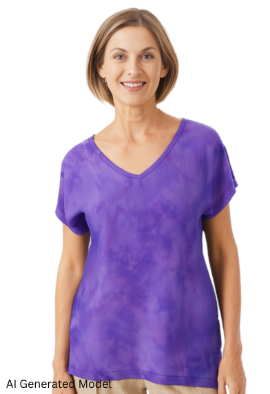 woman wearing a hand dyed silk t in violet against a white background.  AI generated model.
