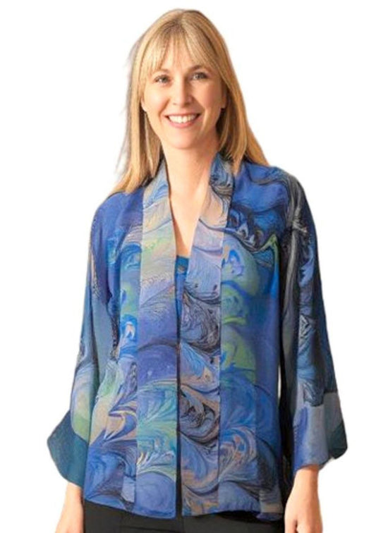 Woman wearing a gray, blue, celery and peach marbled silk kimono on a white background