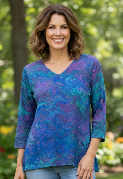 woman wearing a brilliantly marbled silk tunic top standing outdoors