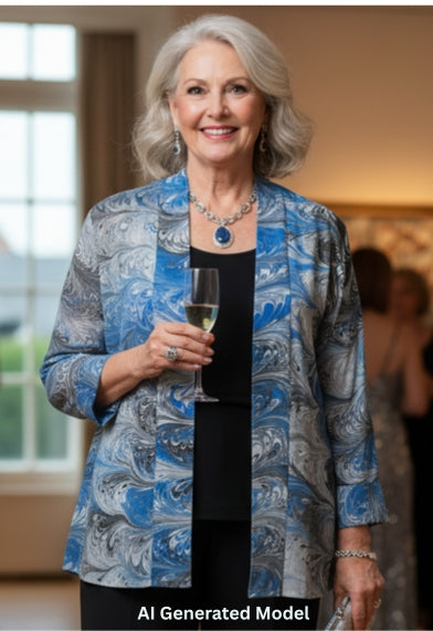 Woman in a blue black and white marbled silk jacket and black pants 