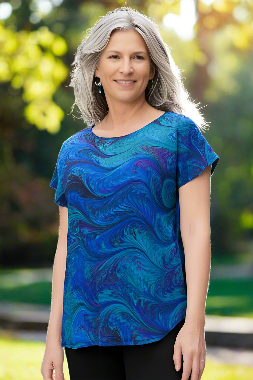 woman wearing a marbled silk top in an outdoor park setting