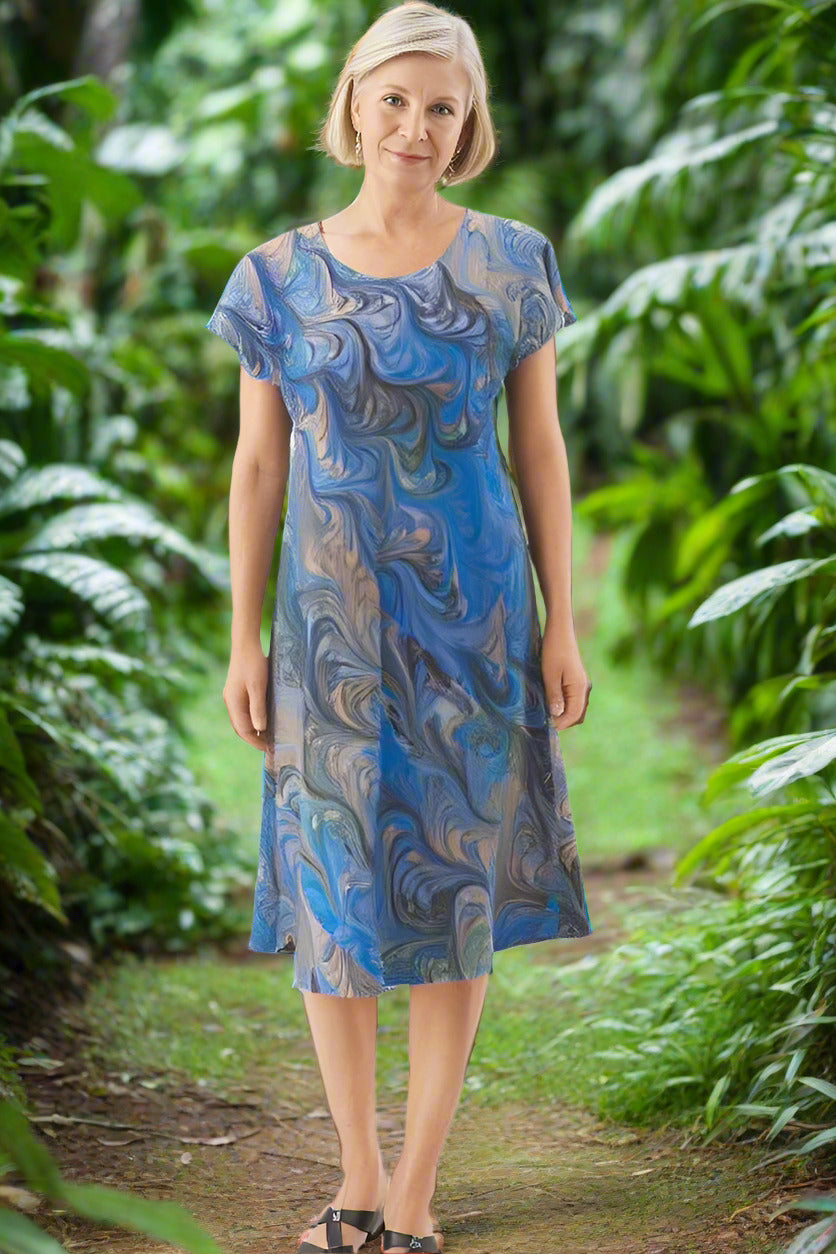 woman wearing marbled silk dress in light blue with gray and peach