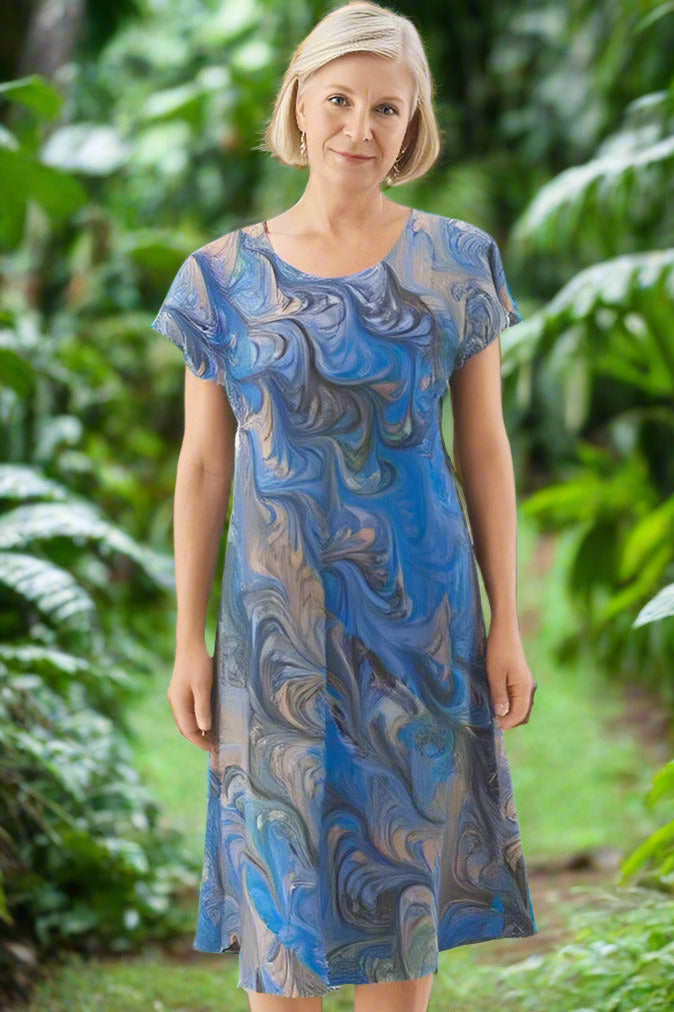 woman wearing marbled silk dress in light blue with gray and peach