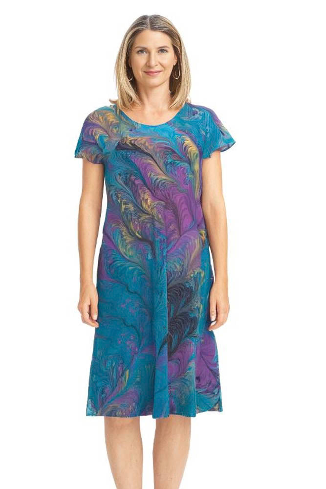 woman wearing marbled silk dress in turquoise, magenta and yellow