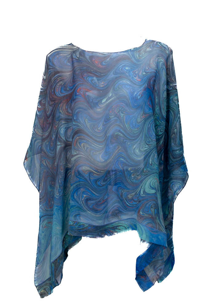 Marbled, sheer poncho and light blue color on mannequin against white background