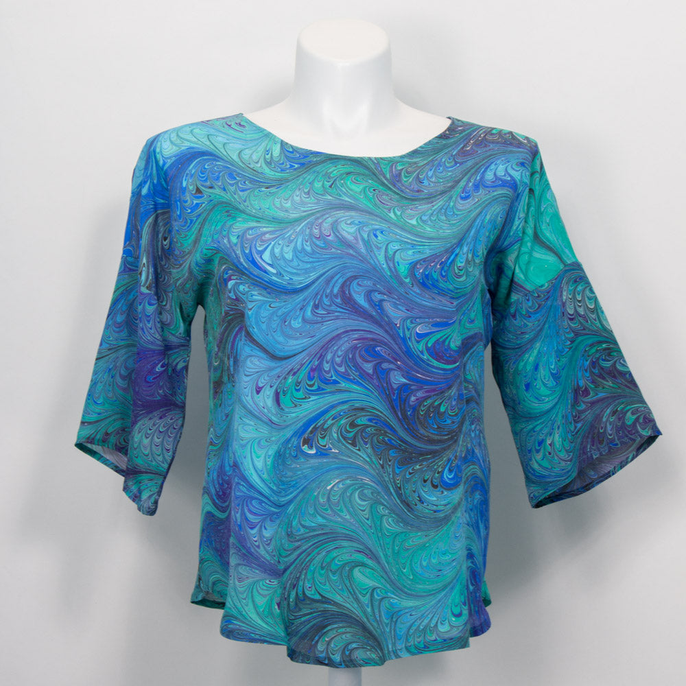 half sleeve silk top with round neck marbled in feathered pattern in teals, blues, green colors