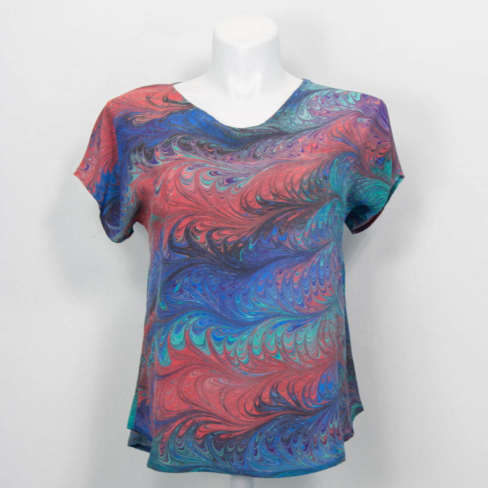 short sleeve summer top marbled in a feathered pattern in blues, greens, purples and red