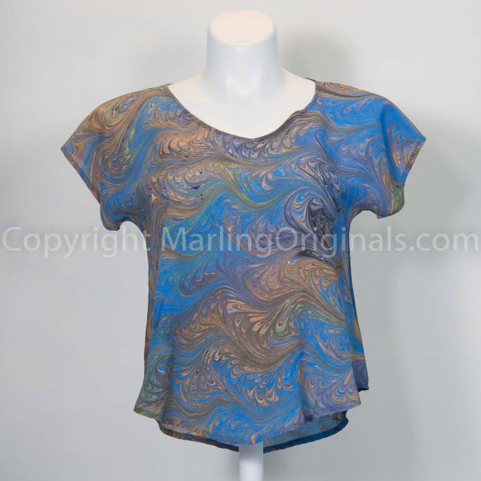 Hand marbled short sleeve top with feathered pattern in blue, gray, peach. 