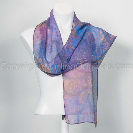 Sheer scarf marbled in a feathered pattern in orchid, soft blue, peach and grey colors