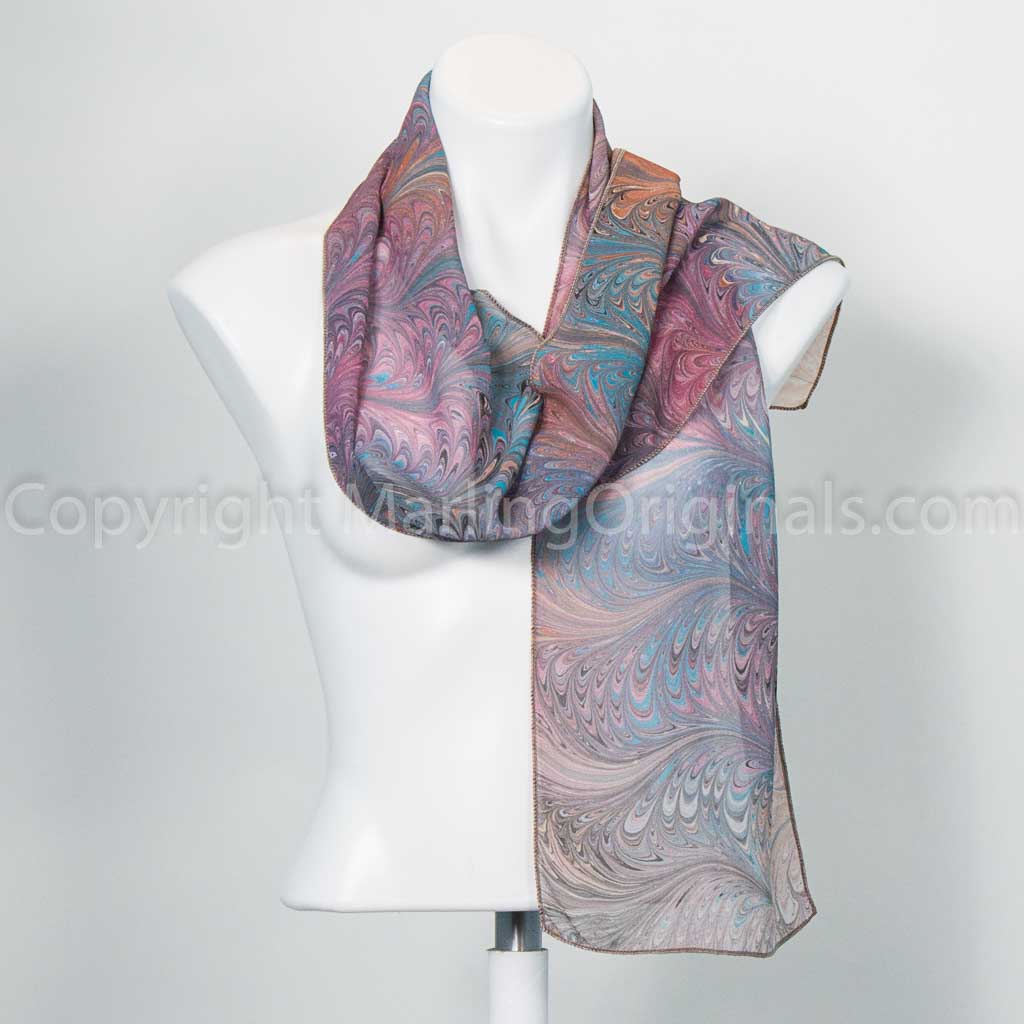 silk scarf feathered with marbling in mauve, teal and brown tones