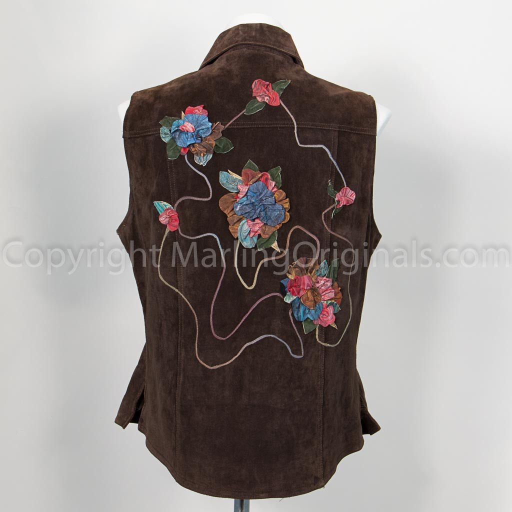 Back of chocolate brown suede jacket with floral design embellishments.