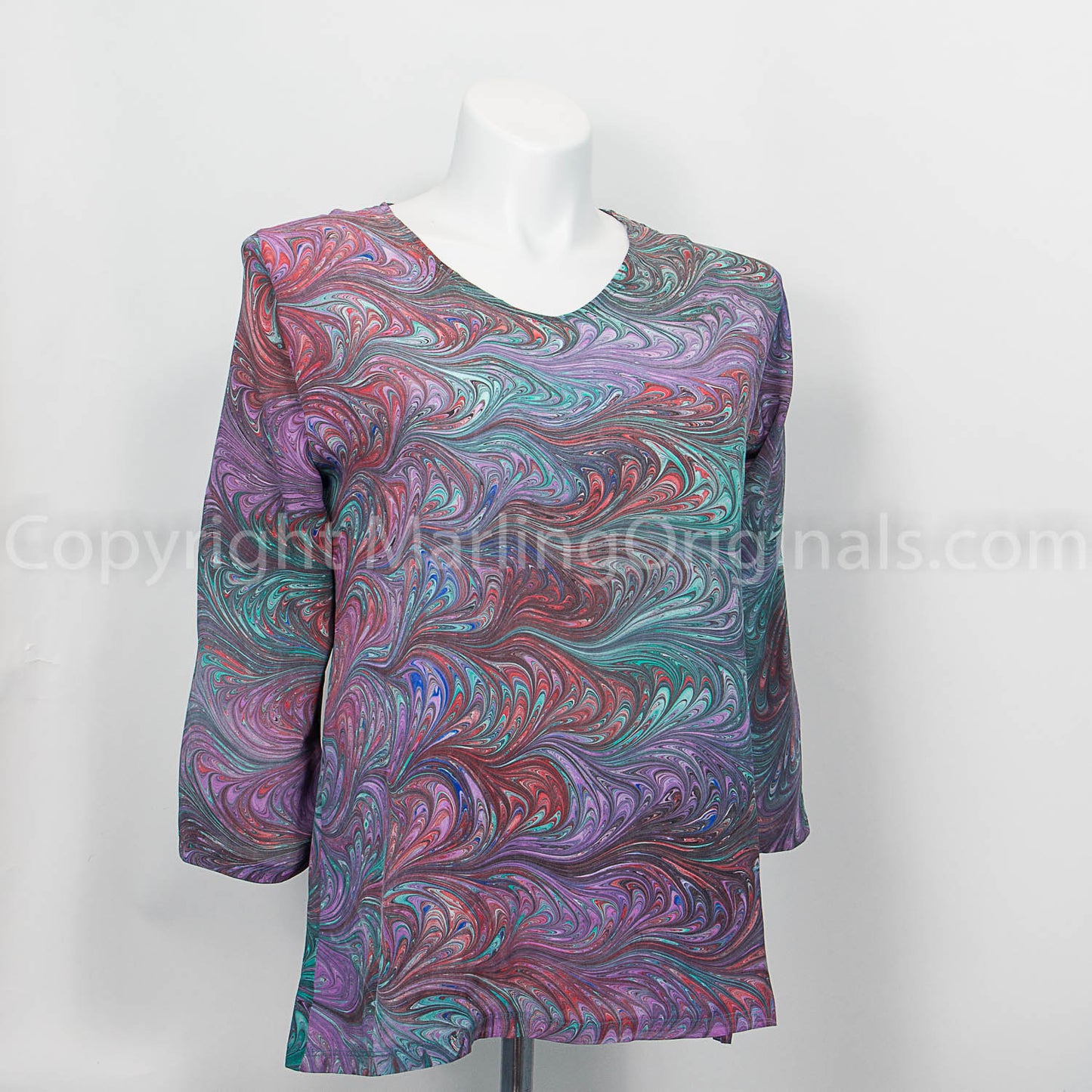 v neck 3/4 sleeve silk tunic with a marbled feathered pattern in lavender, rose, red, green