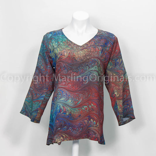 silk v neck top with a hand marbled pattern in shades of deep teal and red