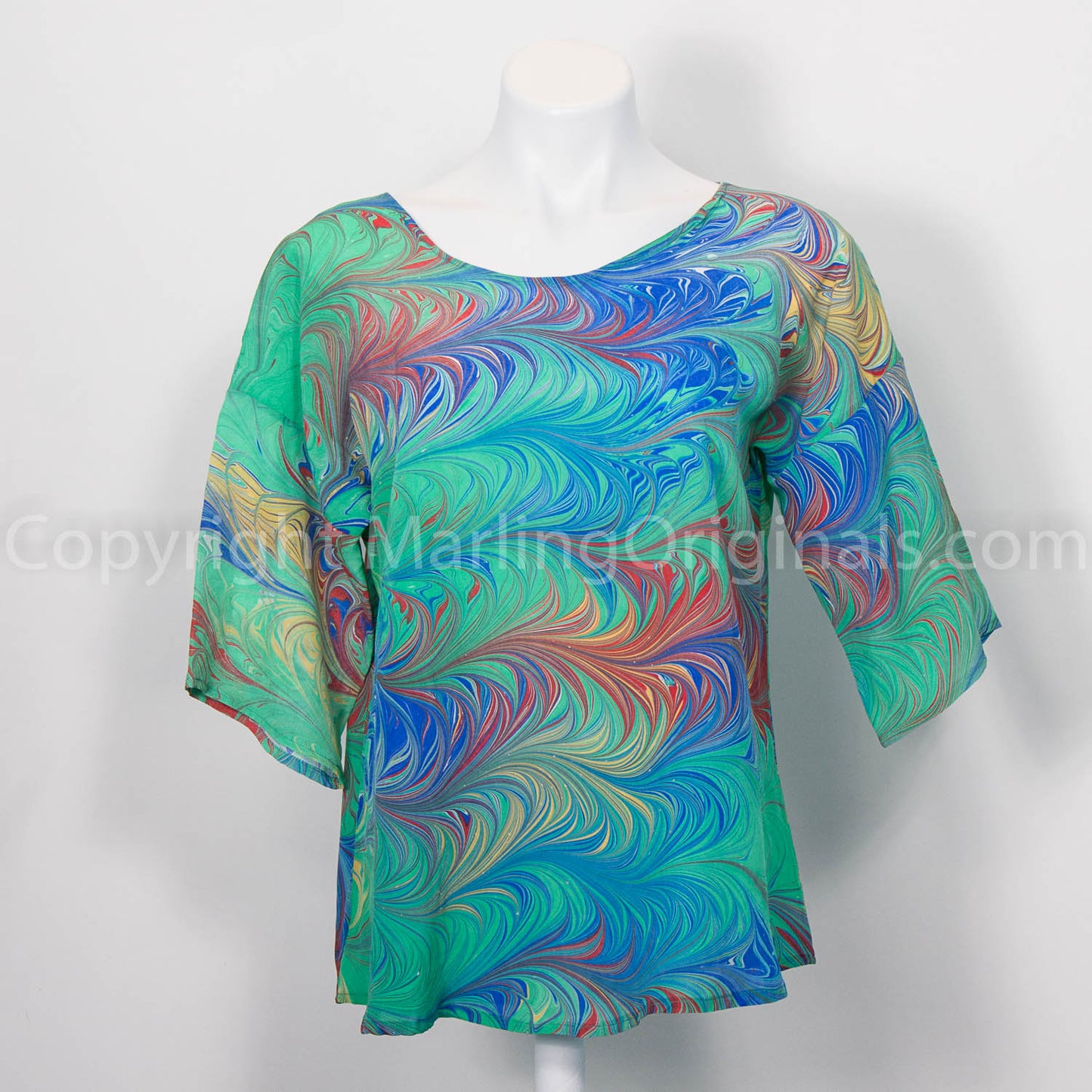 silk top marbled in apple green with accents of red, blue and yellow.  Round neck with half sleeve.