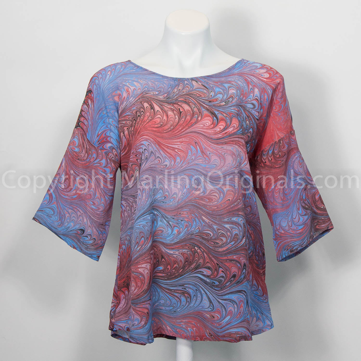 marbled silk top in blues with red, pink and cranberry tones.  Round neck, curved hem, half sleeves.