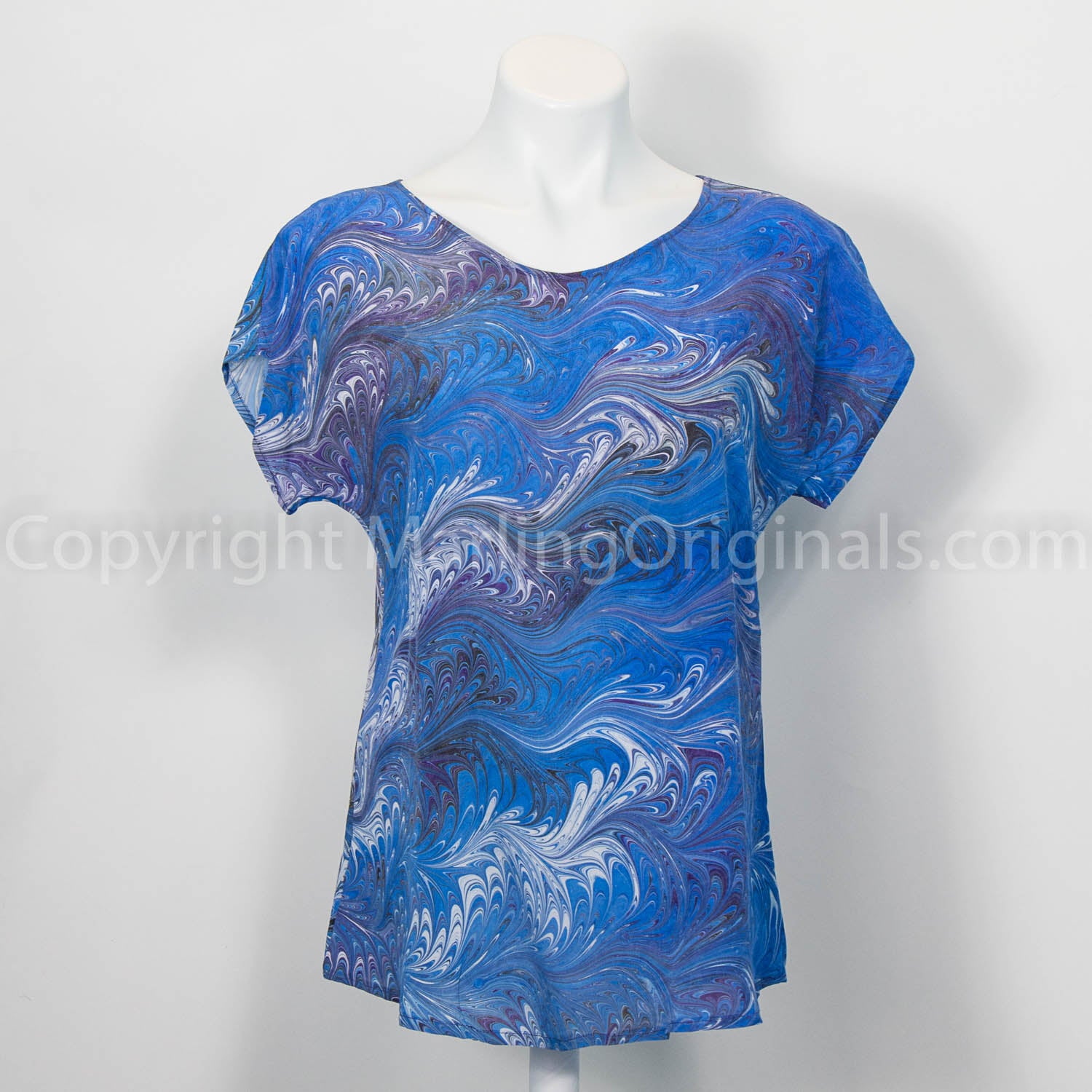 Crepe silk top hand marbled in blue, purple, white and black.  Gorgeous feathering. Short sleeve.
