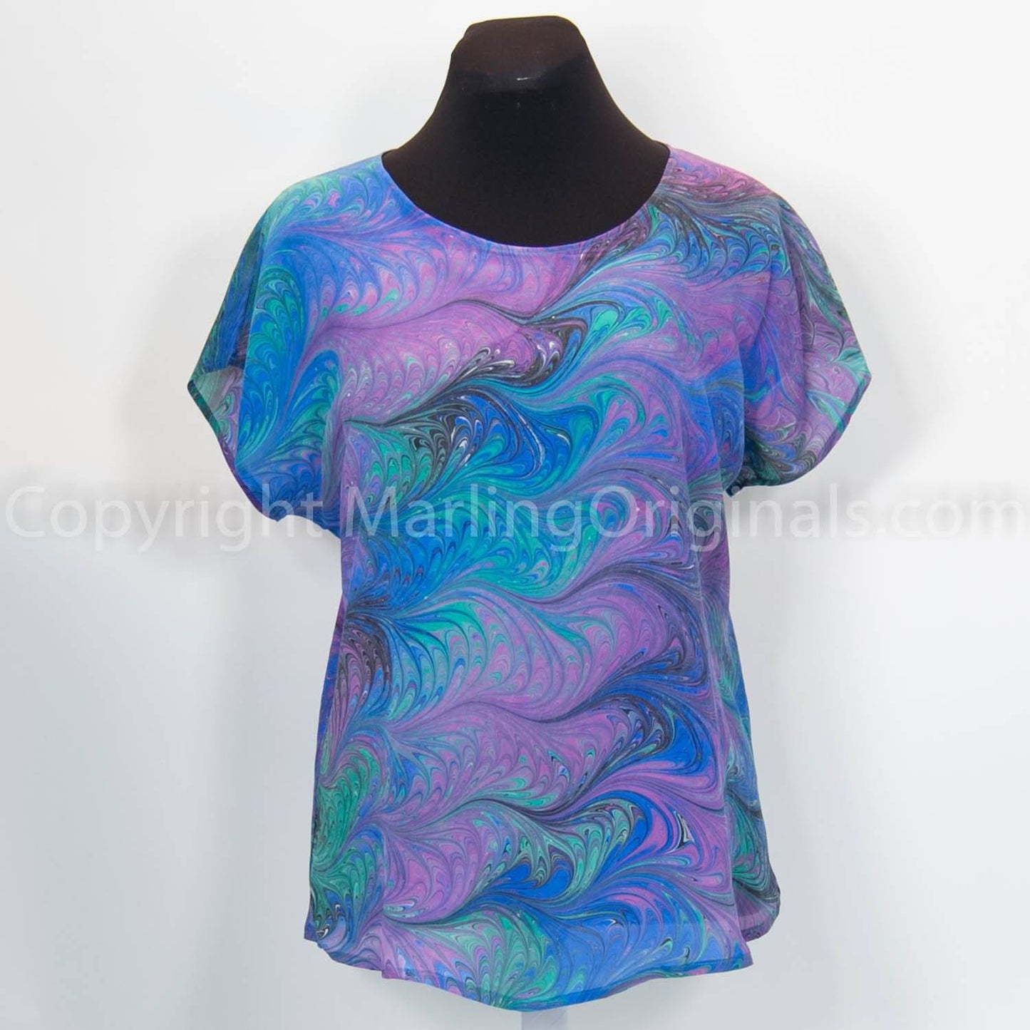 marbled blue silk top in deep jewel tones. Round neckline, curved hemline and short sleeves