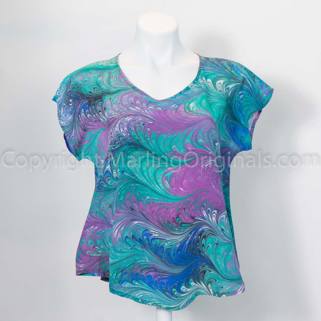 Short sleeve silk top marbled in green, blue, violet with touches of black.