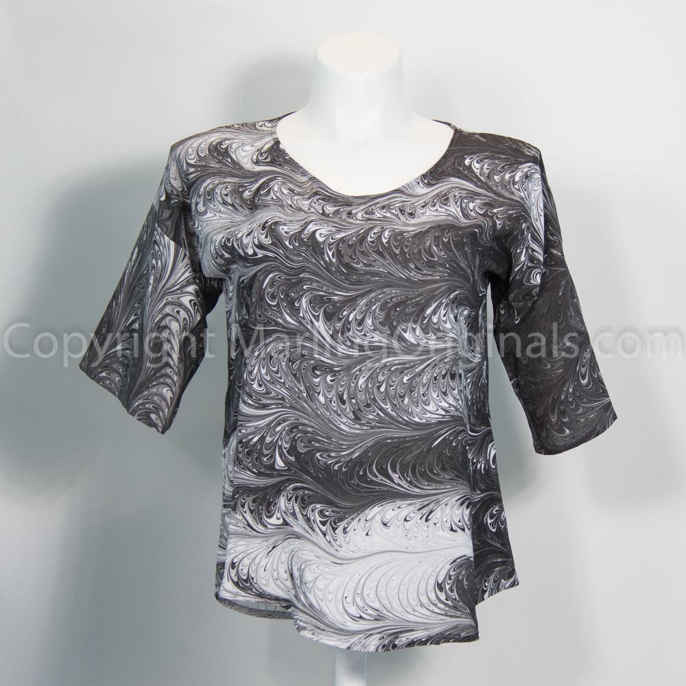 Marbled black and white silk top with round neck, half sleeves and curved hem.