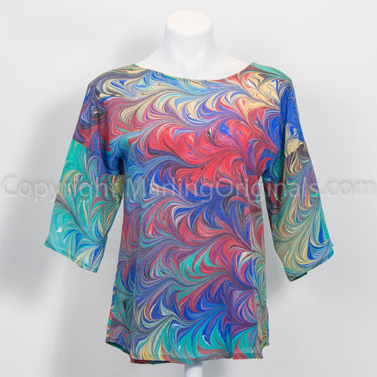 Hand marbled silk top in blue, green, red, yellow, black. Round neck, curved hem, half sleeve