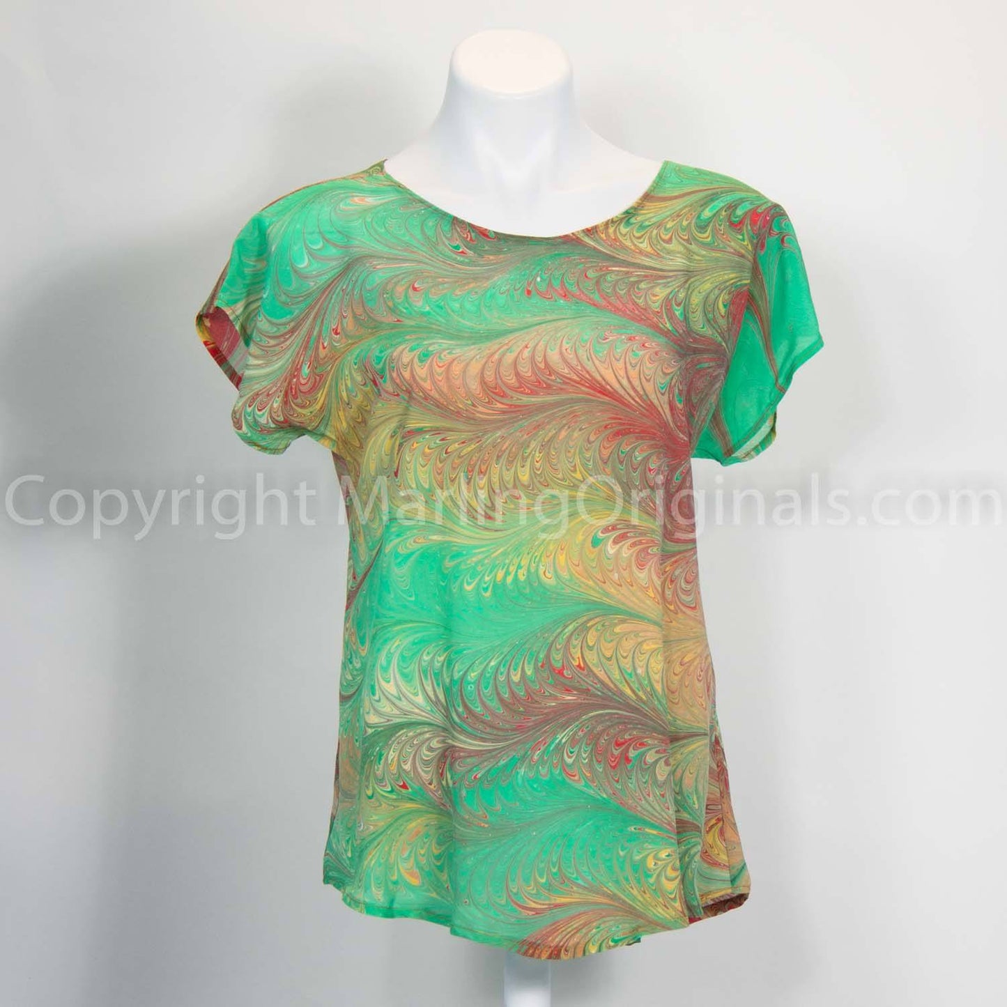 Marbled silk short sleeve top in spring green, sienna, red and gold feathered pattern.  Round neck
