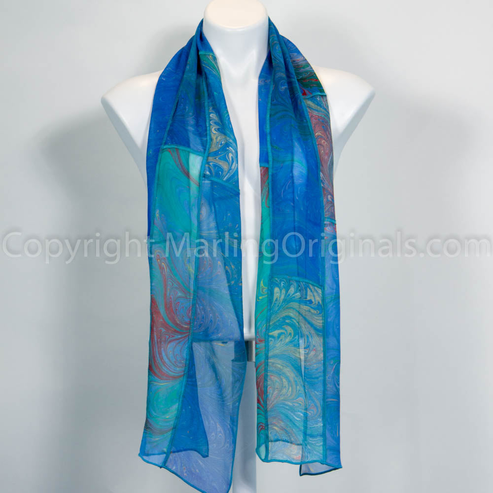 marbled silk blue scarf with accents of red, yellow, green.  Pieced with decorative stitching.  11" x 62"